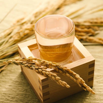Beauty Secrets of Japan Sake Bath Salts in a traditional wooden masu cup with rice stalks for a Japanese ritual