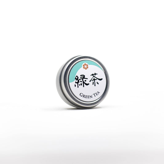 Beauty Secrets of Japan green tea lip balm in a small round metal tin with Japanese kanji and floral logo
