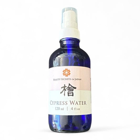 Beauty Secrets of Japan Hinoki Cypress Floral Water in a blue glass spray bottle for facial toning and skin soothing.
