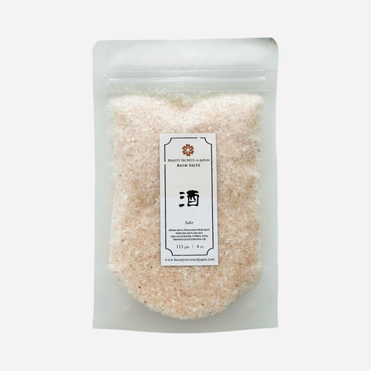 Beauty Secrets of Japan Sake Bath Salts in a clear pouch with pink Himalayan and sea salt blend for a relaxing soak.