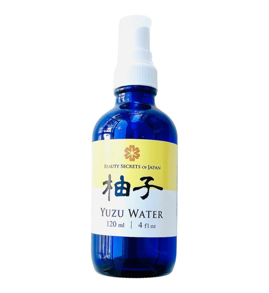 Beauty Secrets of Japan Yuzu floral water in a blue glass spray bottle for facial toning and skin hydration.