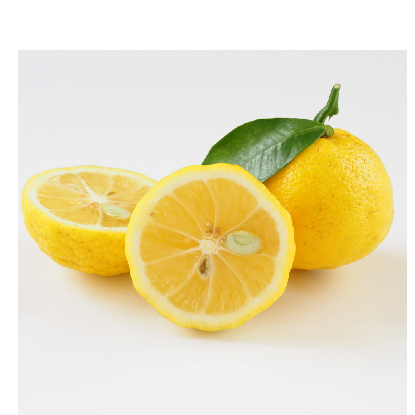 Beauty Secrets of Japan fresh yellow yuzu fruit with a green leaf, whole and sliced, for natural skincare