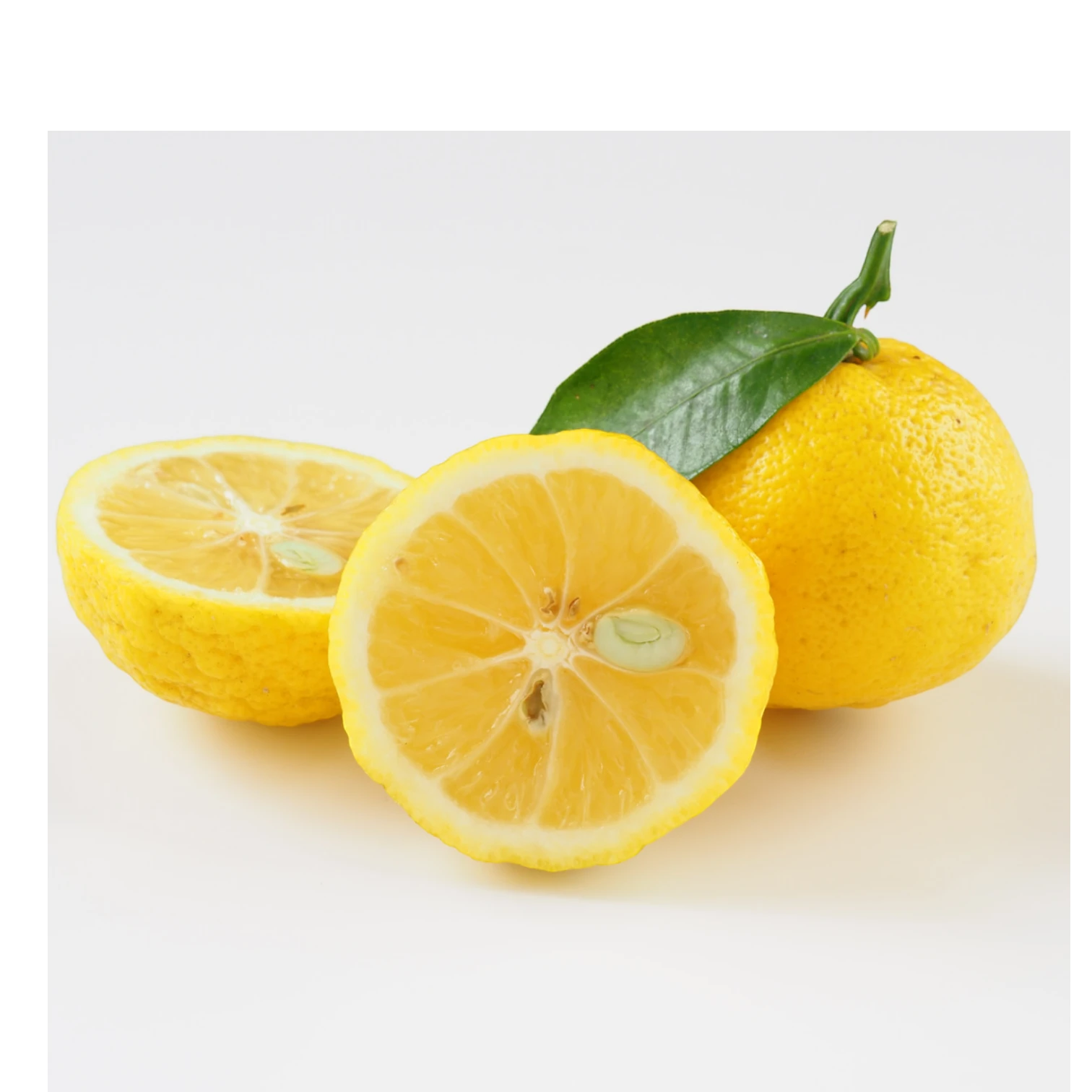 Beauty Secrets of Japan fresh yellow yuzu fruit with a green leaf, whole and sliced, for natural skincare